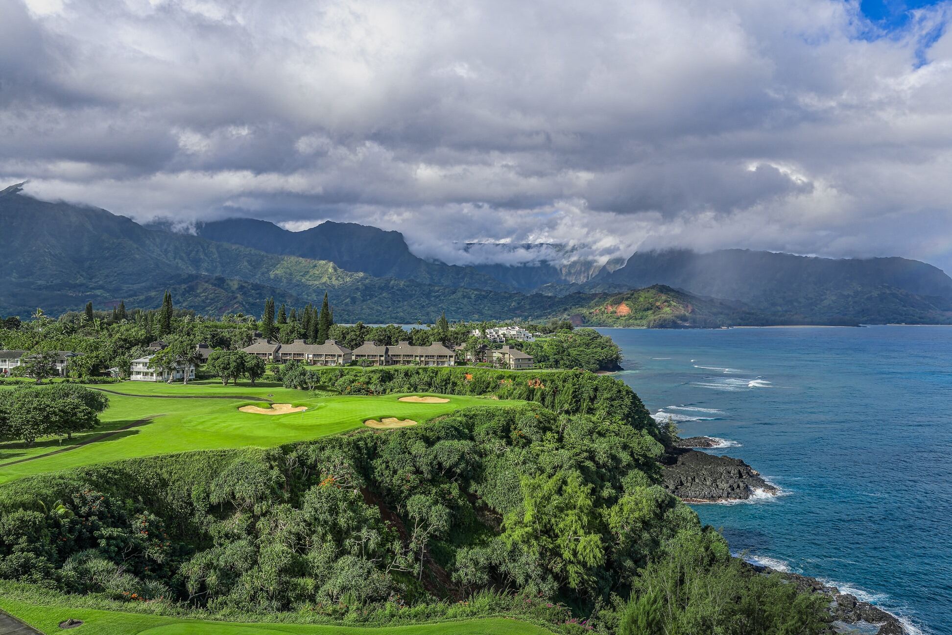 Golf course fairway with view of volcanoes and coastline