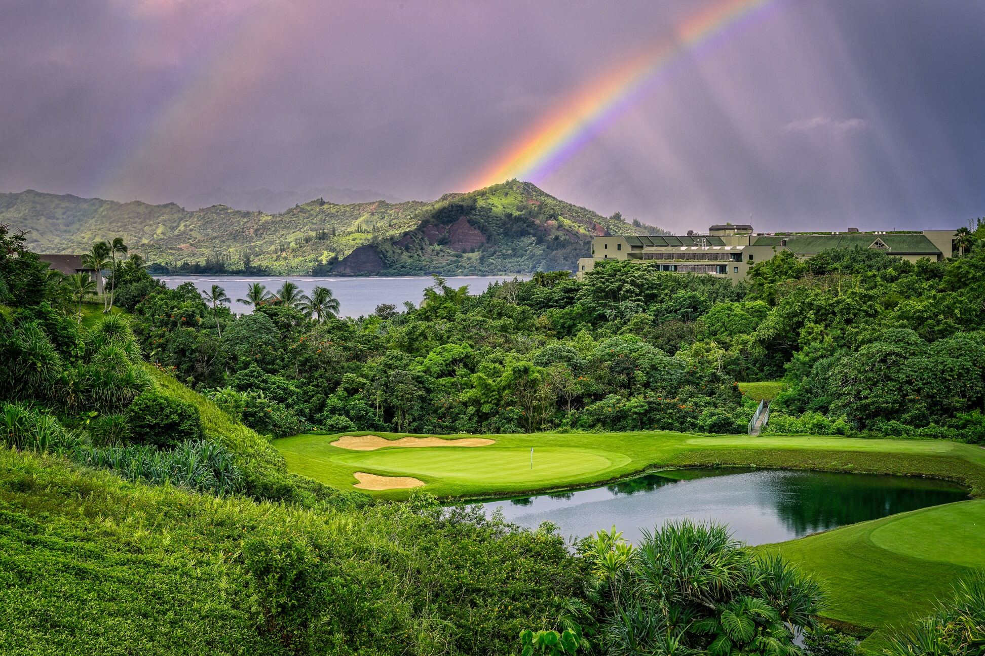Rainbow over mountains on golf course